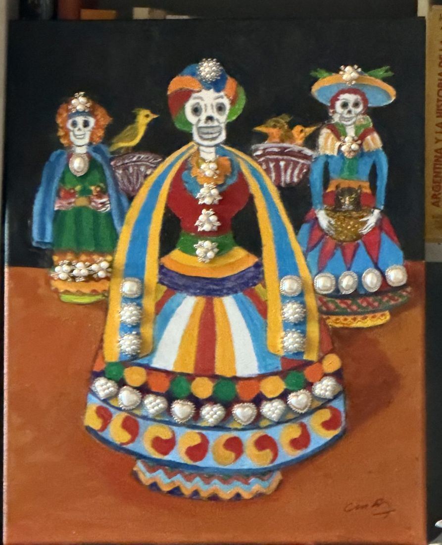 Painting of three colorful Mexican catrina figurines